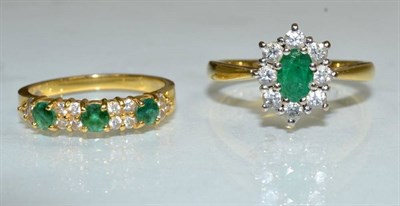 Lot 137 - An 18 carat gold emerald and diamond cluster ring, an oval cut emerald within a border of round...