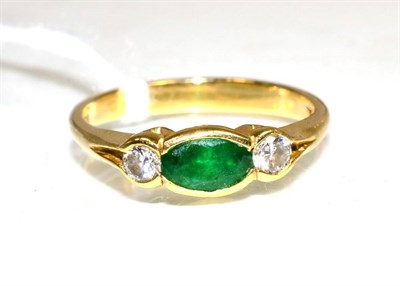 Lot 139 - An 18 carat gold emerald and diamond three ring, an oval cut emerald spaced by round brilliant...