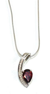 Lot 142 - A garnet and diamond pendant, a pear cut garnet in a claw setting, to a scroll bar channel set with