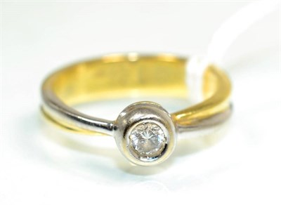 Lot 144 - A solitaire diamond ring, a round brilliant cut diamond in a rubbed over setting, to two colour...