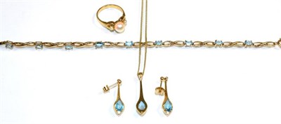 Lot 145 - A 9 carat gold blue topaz necklace and earring suite; a pear cut blue topaz and a round...