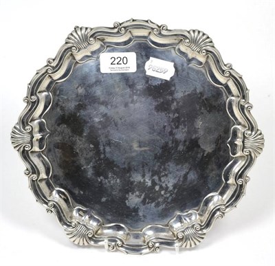 Lot 220 - A silver salver on claw and ball feet, 18.3ozt