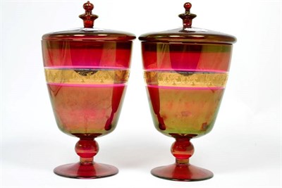 Lot 242 - A pair of Victorian gilt and ruby glass sweet meat jars and covers