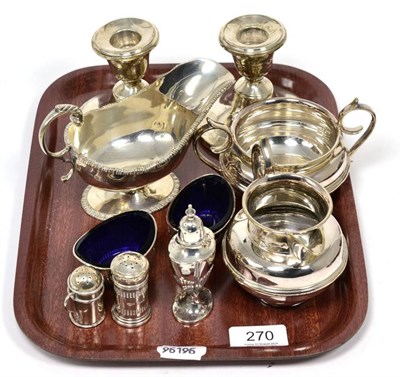 Lot 270 - A group of silver comprising a cream and sugar, sauceboat, pair of salts, pair of weighted...