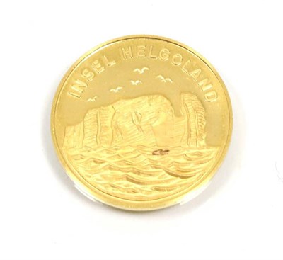 Lot 284 - A Heligoland island commemorative gold medal, stamped 0.986, one side decorated with the island...