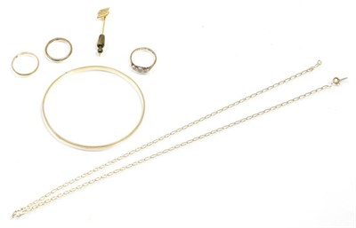 Lot 300 - A 9 carat gold diamond ring; two 9 carat gold rings; a bangle; a fine chain and a stick pin