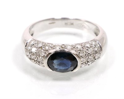 Lot 308 - An 18 carat white gold sapphire and diamond ring, an oval cut sapphire in a tension setting, to...