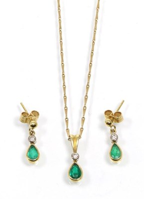 Lot 312 - An 18 carat gold emerald and diamond pendant and earring suite, a round brilliant cut diamond above