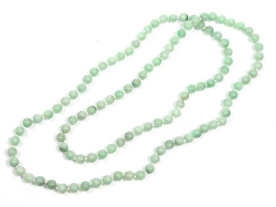 Lot 316 - A jade bead necklace, uniform beads knotted as a continuous strand, length 110cm approximately