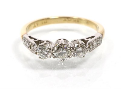 Lot 345 - An 18 carat gold three stone diamond ring, graduated round brilliant cut diamonds in claw settings