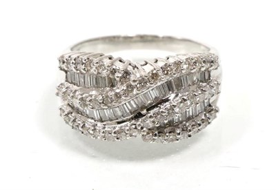 Lot 352 - A diamond ring, crossover bands of channel set baguette cut diamonds, spaced by bands of round...