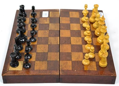 Lot 360 - An early 20th century folding box and wooden chess pieces