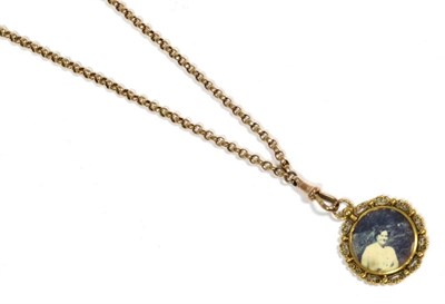 Lot 408 - A faceted belcher chain with clip, length 45cm, suspending a glazed locket pendant, stamped '15CT'