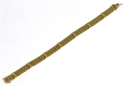 Lot 418 - An 18 carat gold fancy link bracelet, of bar links alternating with x-shaped links, length 19cm