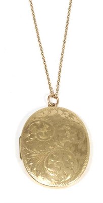 Lot 445 - A large 9 carat gold foliate engraved locket pendant, on chain, measures 6cm by 4cm