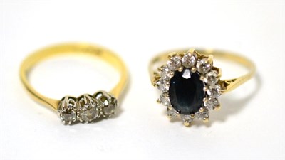 Lot 7 - A three stone diamond ring and a 9 carat gold sapphire and cubic zirconia cluster ring