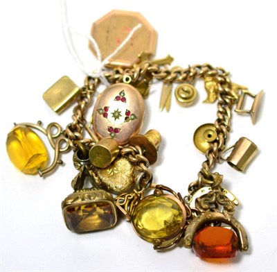 Lot 8 - A charm bracelet with 9 carat gold and other charms