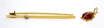 Lot 13 - An enamel ladybird charm, stamped '750' and a diamond set bar brooch (2)