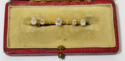 Lot 15 - A diamond bar brooch, a knife edge bar set with graduated old cut diamonds, total estimated diamond