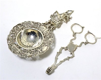 Lot 26 - A pair of Georgian silver sugar nips; a Continental silver tea strainer with import marks