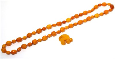 Lot 27 - An amber bead necklace, a continuous knotted strand of graduated oval and off round amber...