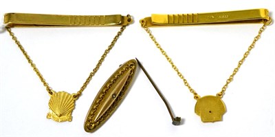 Lot 28 - A 9 carat gold and diamond ";Shell"; service tie slide, a metal example and a 9 carat gold...