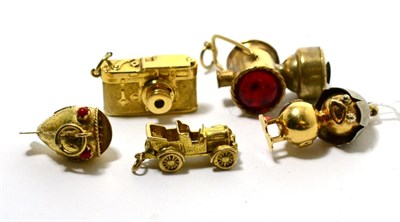 Lot 33 - An 18 carat gold chick charm, a Stanhope viewer camera charm, a 9 carat gold car charm, a fish...