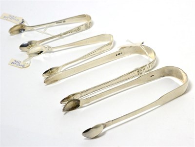 Lot 34 - Four silver sugar nips including Georgian and Victorian examples