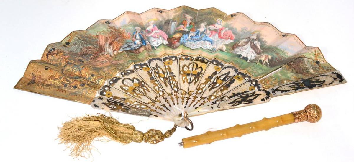 Lot 59 - A mother of pearl fan with carved sticks and paper mount, decorated with a pastoral scene,...