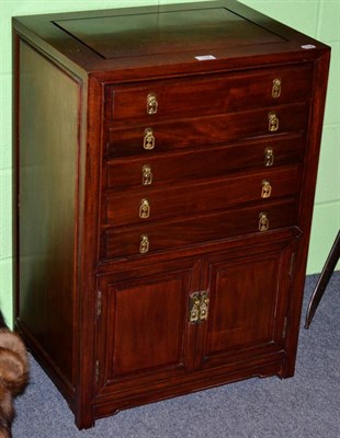 Lot 154 - A Chinese style canteen cabinet fitted with five drawers and a pair of cupboard doors...