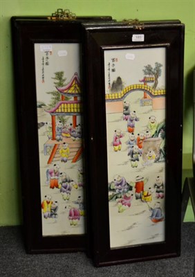 Lot 185 - A set of four Chinese polychrome porcelain panels decorated with children, each in hard wood frames