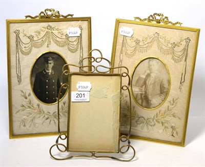 Lot 201 - A pair of gilt metal strut picture frames with embroidered masks and one other (3)