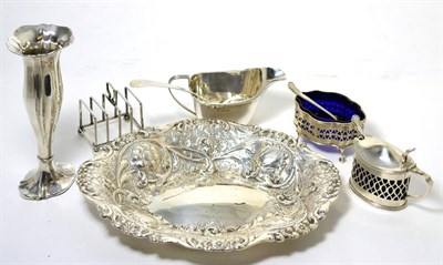 Lot 208 - A group of silver comprising; a repousse oval dish; mustard pot and salt with pierced sides;...
