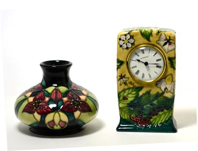 Lot 216 - A Moorcroft pottery timepiece in the Fruit Garden pattern by Nicola Slaney, 16cm and a...