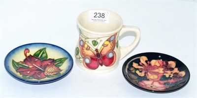 Lot 238 - A modern Moorcroft mug and two coasters (3)