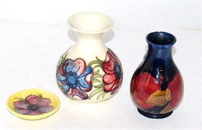 Lot 239 - A William Moorcroft Pomegranate vase and two Walter Moorcroft Anemone items (3)