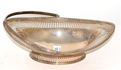 Lot 255 - A pierced silver navette form swing handled basket