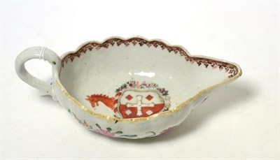 Lot 293 - A Chinese armorial porcelain sauce boat, circa 1770, of fluted oval form painted with the arms...