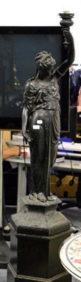 Lot 1152 - ^ A reproduction spelter figure of a classical maiden holding a torch aloft, on a plinth base...