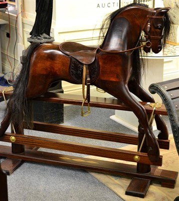 Lot 1154 - A hand carved mahogany rocking horse on a trestle base by King's Horses, Stretton Road, Leicester