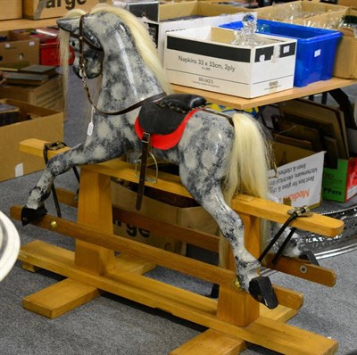 Lot 1155 - A dapple grey rocking horse on trestle base