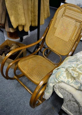 Lot 1170 - A Bentwood rocking chair, with caned back support and seat with rounded arms and scrolled...