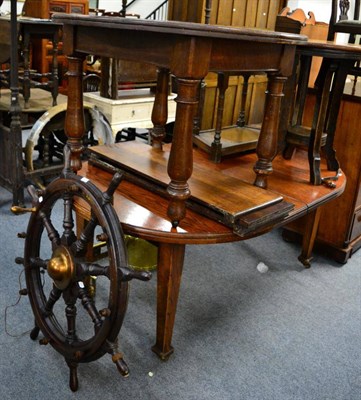 Lot 1197 - ^ An oak D end dining table, another oak table, an occasional table and a ships wheel converted...