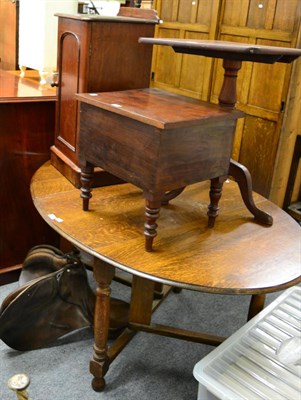 Lot 1201 - A 19th century mahogany tilt top tripod table, a pot cupboard, a commode together with a...