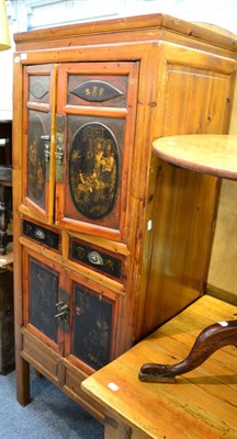 Lot 1219 - An Oriental cabinet with lacquered panels