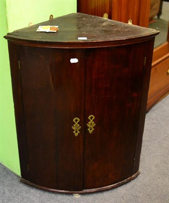 Lot 1265 - A 19th century mahogany bow fronted hanging corner cupboard