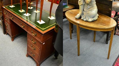 Lot 1275 - A reproduction leather inset pedestal desk together with an oval occasional table