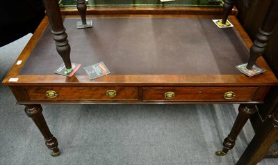 Lot 1278 - A reproduction mahogany leather inset writing table, fitted with two drawers and raised on...