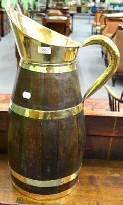 Lot 1282 - A wood and brass jug