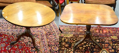 Lot 1291 - ^ A George III oak tilt top tripod table with a circular top and another rectangular topped example